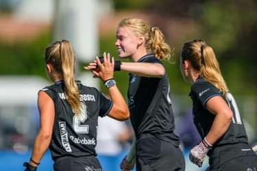 Lilly Stoffelsma feliciteert Amy van den Bosch na een HGC-doelpunt.